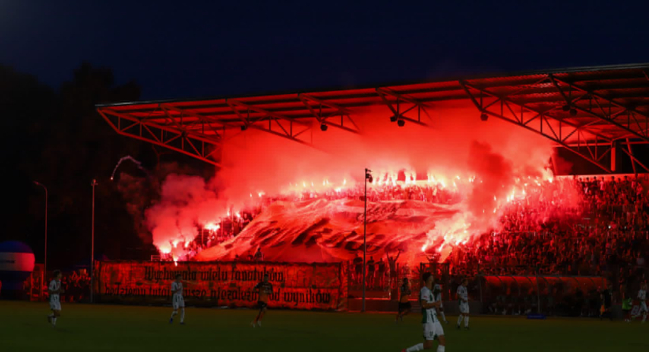 Home supporters with flares during a night match