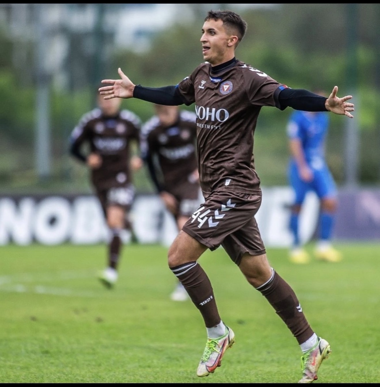 Celebrating a goal with arms raised